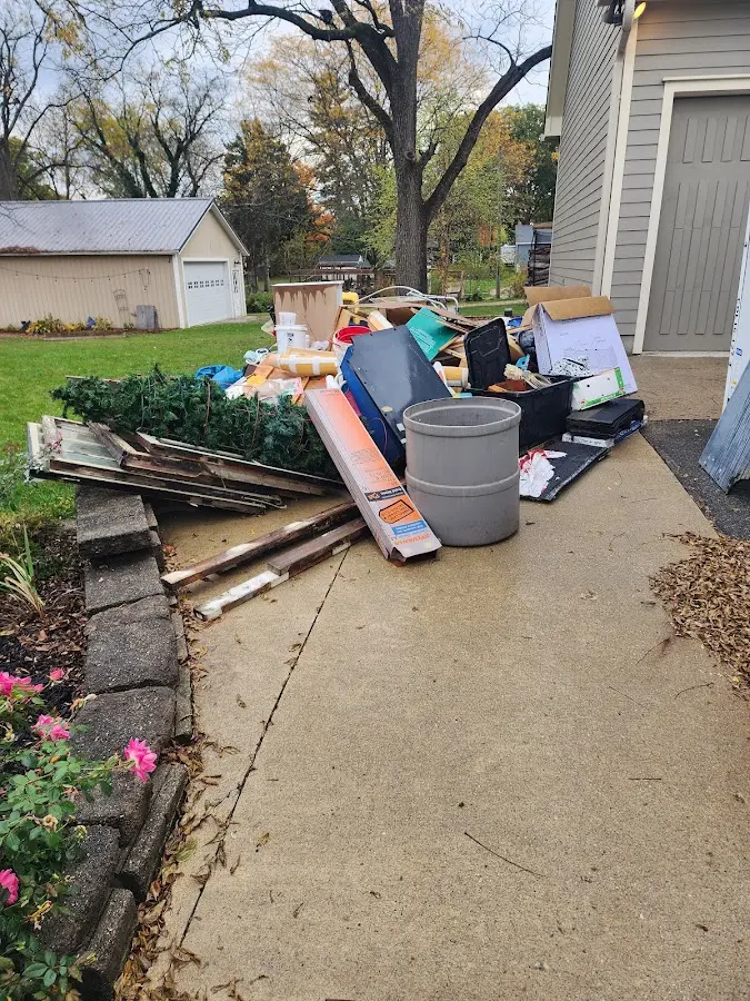 Dumpster being loaded with debris for 3 Yard Dumpster Rental in Northwoods